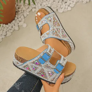 Side view of platform slide sandals decorated with pearls and colorful rhinestones