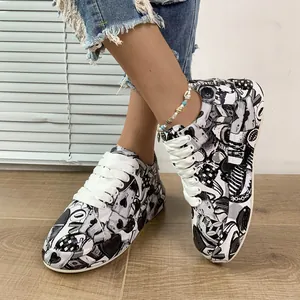 Detailed view of women's graffiti sneakers with black and white poker card pattern.