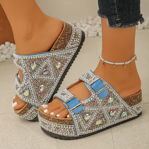 Close-up view of luxury sparkling pearl and rhinestone platform sandals with blue buckles