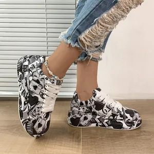 Close-up of women's graffiti print platform sneakers with white laces on a model
