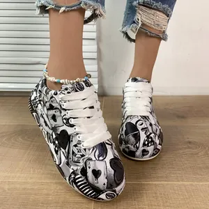 Detailed view of stylish graffiti pattern on black and white chunky sneakers