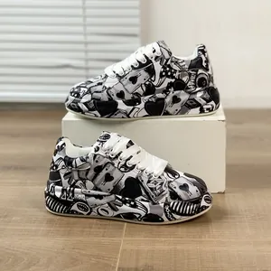 Detailed side view of stylish black and white graffiti print platform sneakers