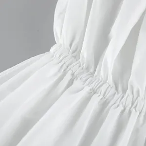 Detailed macro view showing the elasticated shirred waist of a white summer tube top