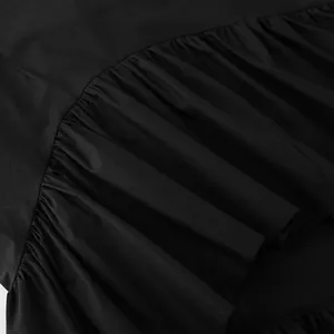 Close-up detail showing the ruffled hem and fabric texture of a French style black A-line skirt