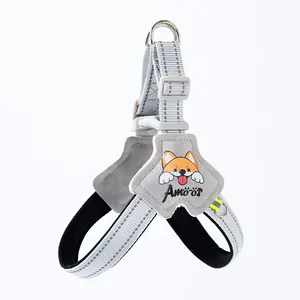 Detailed view of a grey reflective dog harness featuring a cute cartoon dog logo