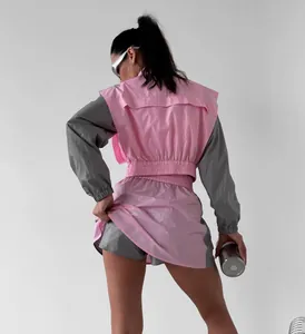 Back view of women's pink and grey color-block sports set showing elasticated waist.