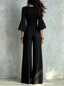 Elegant black bell-sleeve wide-leg jumpsuit with high-waist belt shown from the back