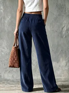 Detailed back view of dark blue vintage corduroy wide-leg pants with elastic waist on a model