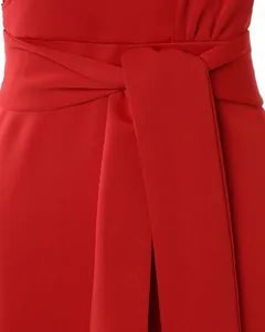 Close-up of the elegant waist tie detail on a vibrant red evening dress