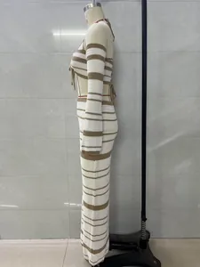 Side view of a striped long-sleeve halter top and maxi skirt set on a mannequin.