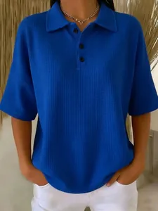 Detailed view of the high-quality waffle texture on a vibrant blue women's polo t-shirt