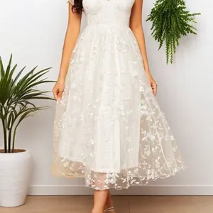 Detail showing white lace V-neck dress with floral embroidery and tiered tulle skirt