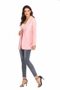 Detail view of a stylish pink slim fit blazer with notch lapel on a female model.