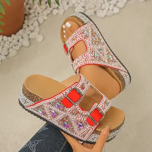 Close-up of red platform sandals featuring intricate pearl and rhinestone embellishments