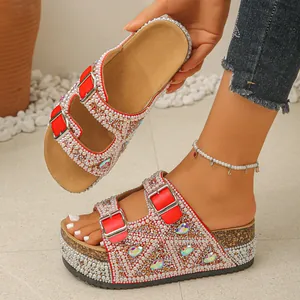 Close-up detail of women's red platform sandals with pearl and rhinestone embellishments