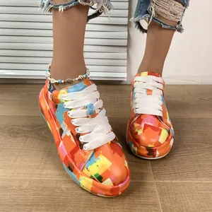 Detailed view of vibrant graffiti-patterned platform sneakers featuring white laces
