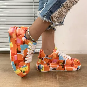 Close-up of colorful graffiti pattern platform sneakers with lace-up detail for women