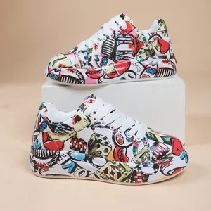 Detail of colorful graffiti pattern on women's thick sole sneakers with lace-up style.