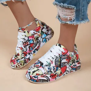 Detailed view of stylish graffiti print women's sneakers with chunky white soles.