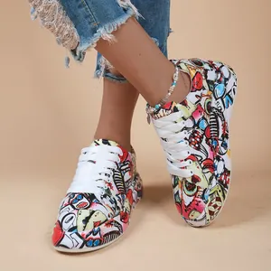 Detailed shot of trendy graffiti-printed sneakers with thick soles and white laces