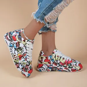 Detail view of women's vibrant graffiti patterned lace-up sneakers with thick soles