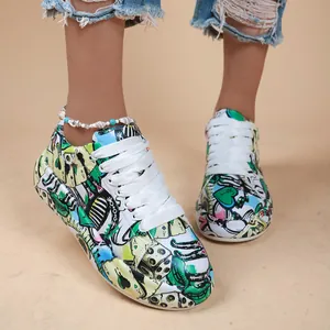 Detailed view of colorful graffiti print sneakers with platform sole and white laces.