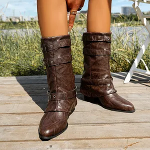 Detail of brown pointy-toe buckle boots with trendy pant-leg design and chunky heel.