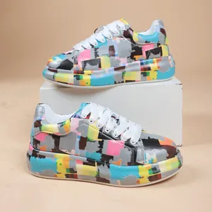 Close-up of vibrant graffiti print platform sneakers for women with white laces.
