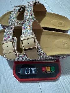 Detailed view of rhinestone cork sandals weighing 637g on a red digital scale