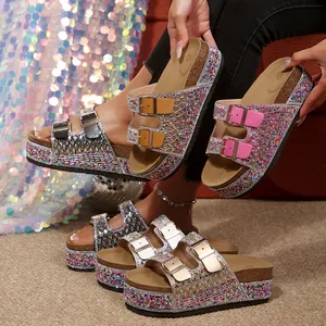 Detail showing multiple colors of sparkling rhinestone platform slides for women