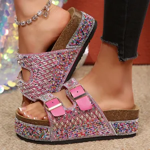 Close-up of pink rhinestone platform sandals with colorful beads and double buckles