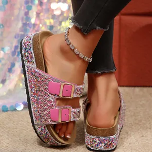 Detail of pink rhinestone double-buckle sandals with colorful beads on cork platform