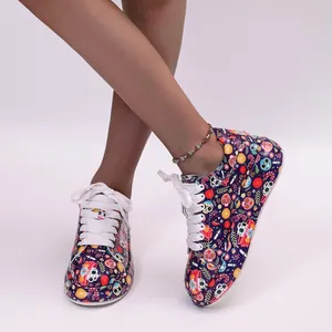 Detailed view of colorful sugar skull pattern sneakers with thick white laces and soles