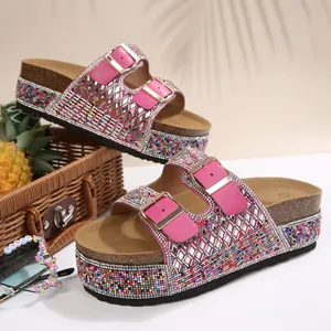 Detailed view of pink rhinestone platform sandals with double buckles and cork sole