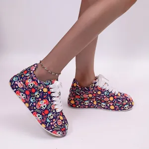 Macro view of women's platform sneakers with vibrant sugar skull and floral graffiti patterns