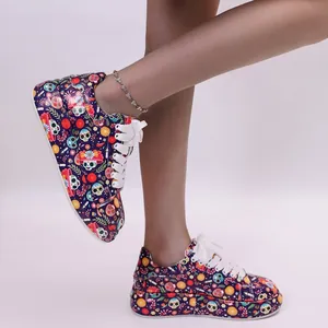 Detailed view of women's colorful sugar skull print platform sneakers with white laces