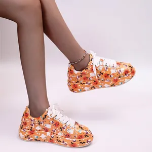 Side view of women's orange platform sneakers featuring a Halloween themed pattern.