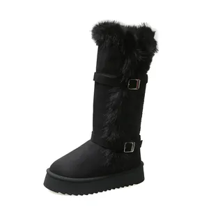 Detail shot of black faux fur high-top snow boots with platform sole and buckles