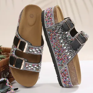 Detailed view of women's rhinestone cork platform sandals with shiny double buckles