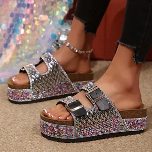 Detail view of colorful beaded platform slides with rhinestones and double buckles.