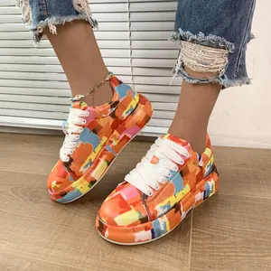 Colorful graffiti print thick-soled sneakers for women with white laces and a modern artistic style