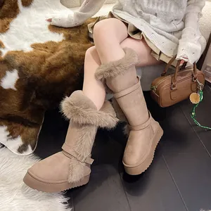Detailed view of women's tall beige snow boots with thick faux fur trim and platform sole