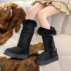 Close-up view of black tall snow boots featuring cozy fur trim and thick platform soles.