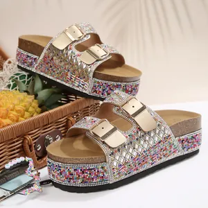 Detailed view of rhinestone and colorful beaded platform sandals with gold buckles
