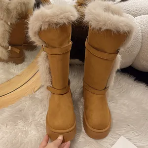 Detail of camel tall snow boots with plush fur trim and platform sole for winter