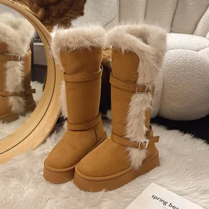 Close-up view of tall camel-colored snow boots featuring plush faux fur and buckles.