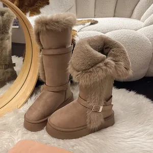 Close-up of warm tall snow boots featuring thick faux fur lining and chunky platform soles.