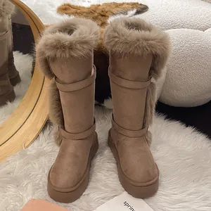 Close-up of stylish tall snow boots with plush faux fur trim and thick platform soles