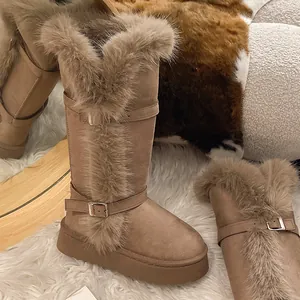 Detailed view of women's tall snow boots with faux fur trim and buckle straps.