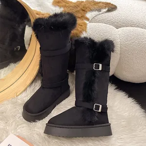 Close-up of black tall snow boots featuring warm faux fur trim and buckle detail.